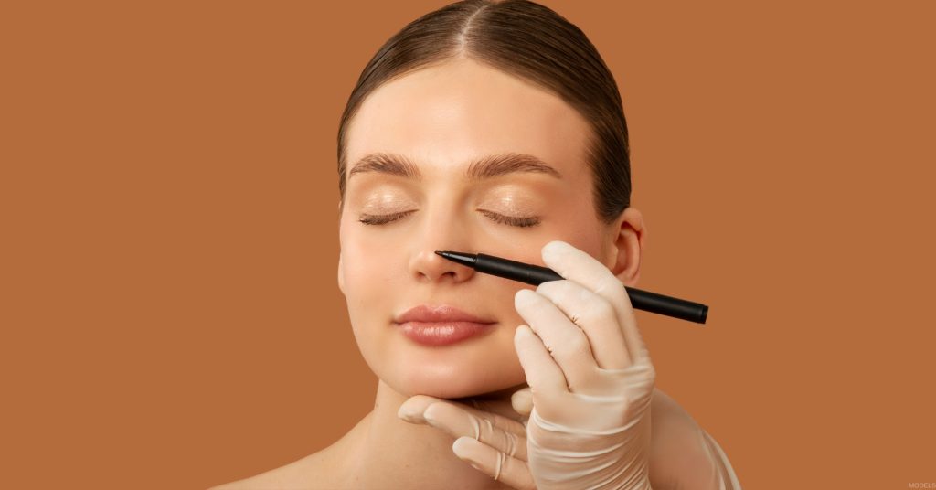 Woman having her nose examined during a rhinoplasty consultation (model).