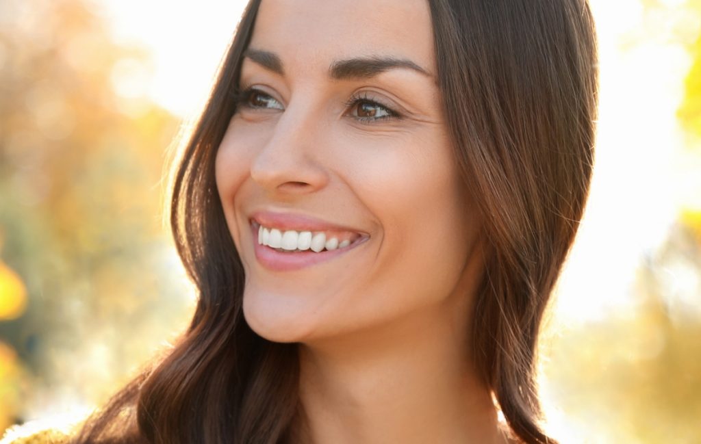 Brunette in the park smiling