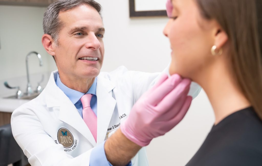 Dr Davis inspecting a client's face