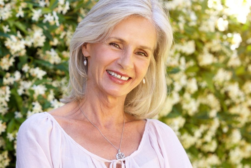 woman in her garden smiling