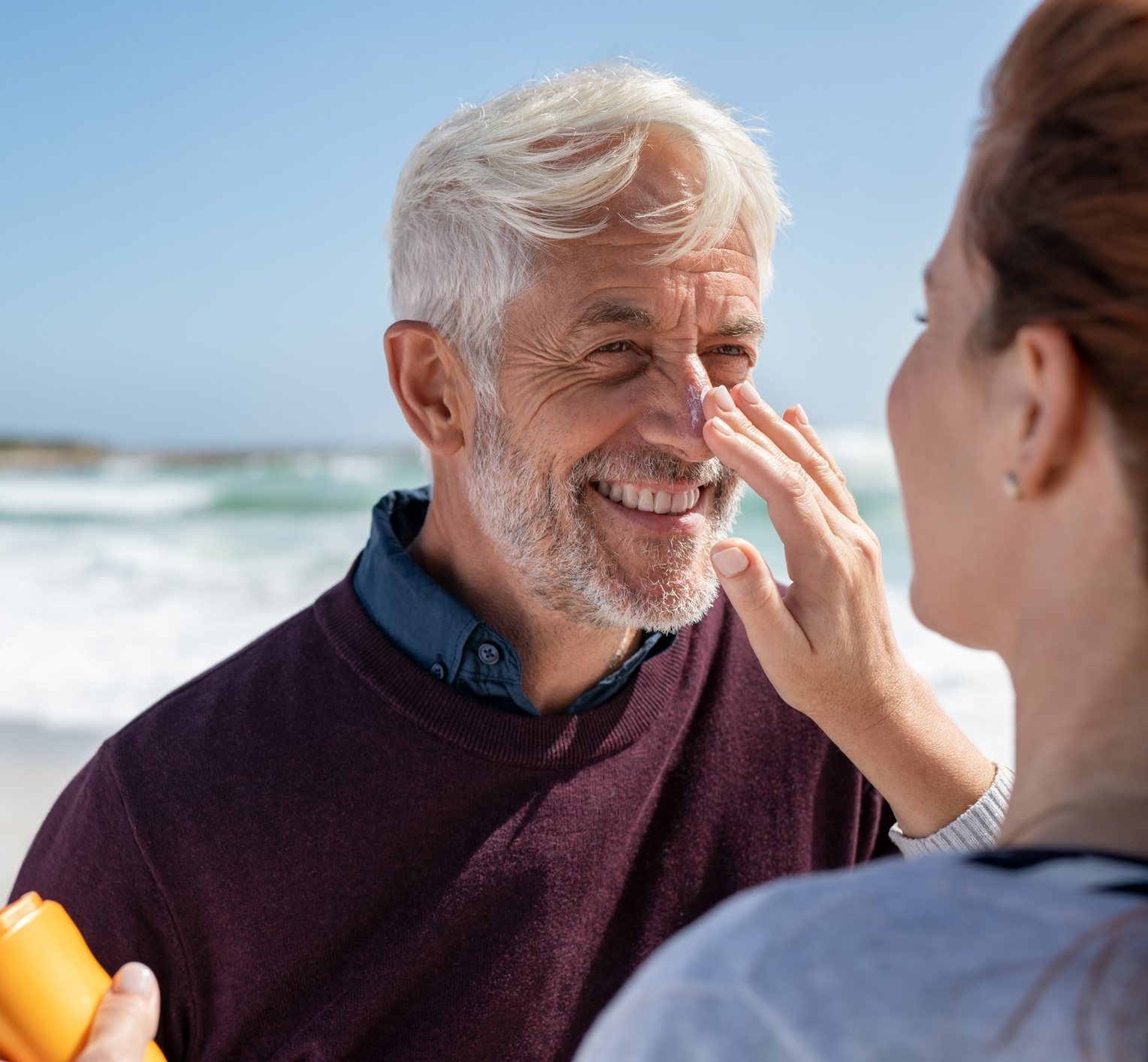 Woman applying sunscreen on senior man nose Rhinophyma in Tampa and St. Petersburg, FL