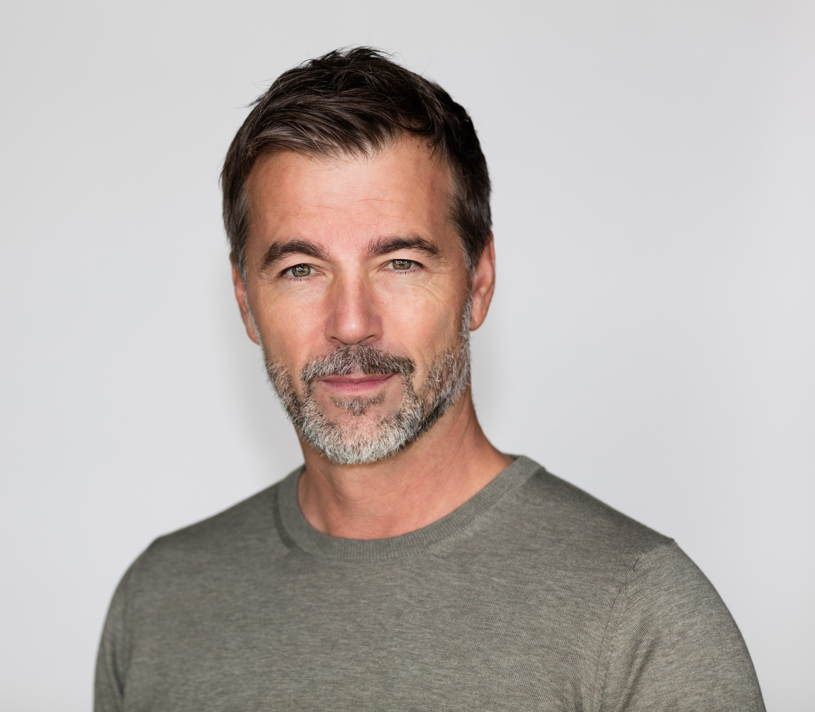 Portrait Of A Mature Man with a Little smile At The Camera. Right side of the picture. Eyelid Ptosis in Tampa and St. Petersburg, FL